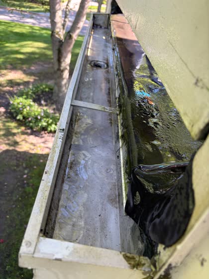 The same gutter emptied, still wet from being rinsed.